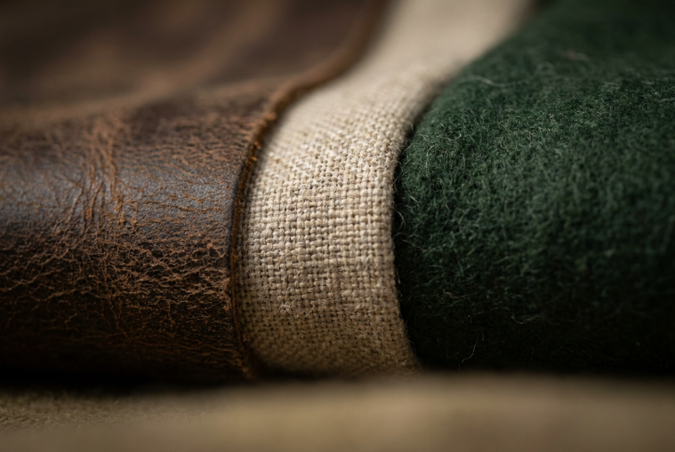 Close-up macro view showcasing distressed leather, burlap, and wool textures