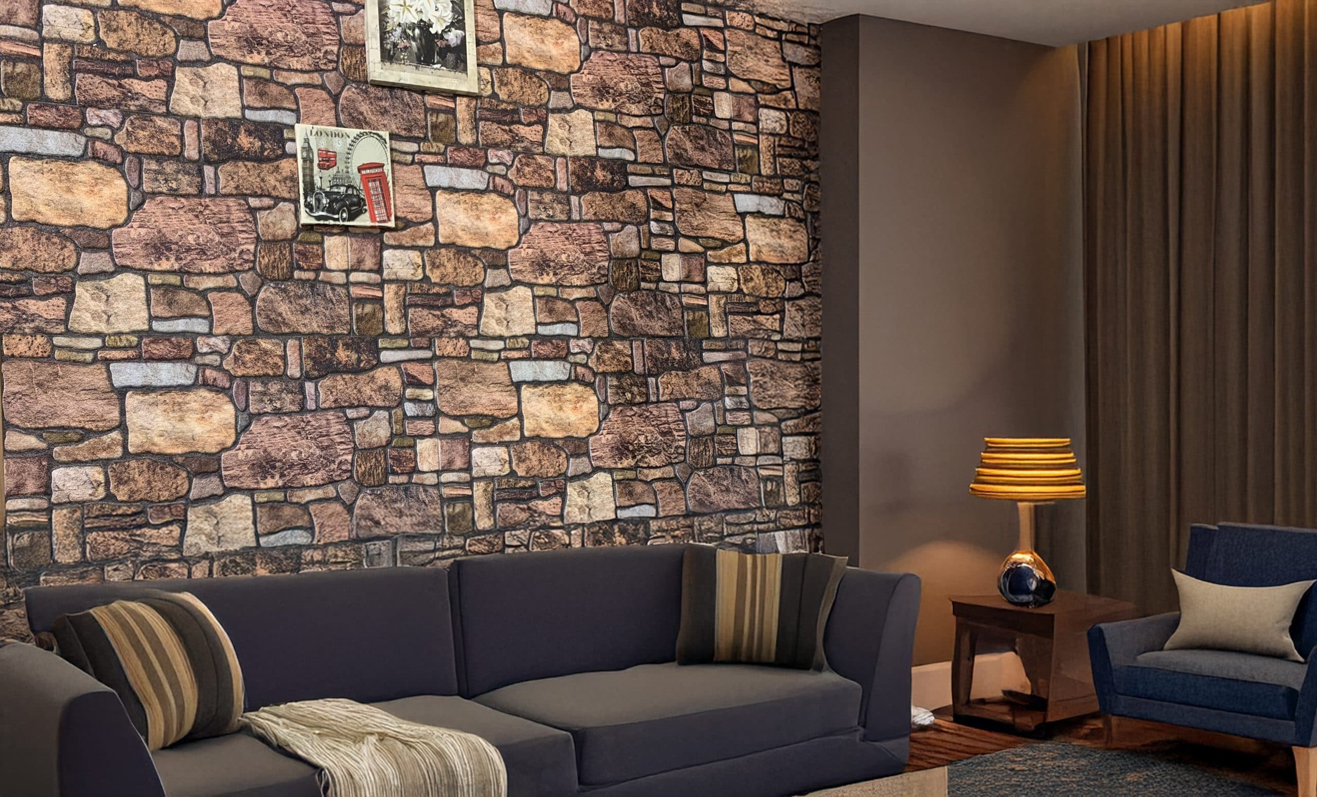 Living room with faux stone wall panel, gray sofa, and warm lighting setup.